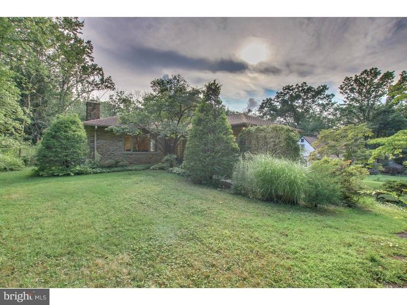 stone huntingdon valley home with covered patio deep backyard