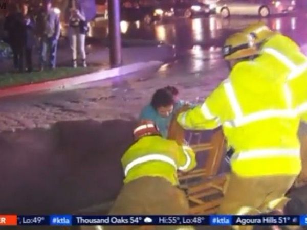 Woman rescued after sinkhole swallows auto Woman rescued after sinkhole swallows auto